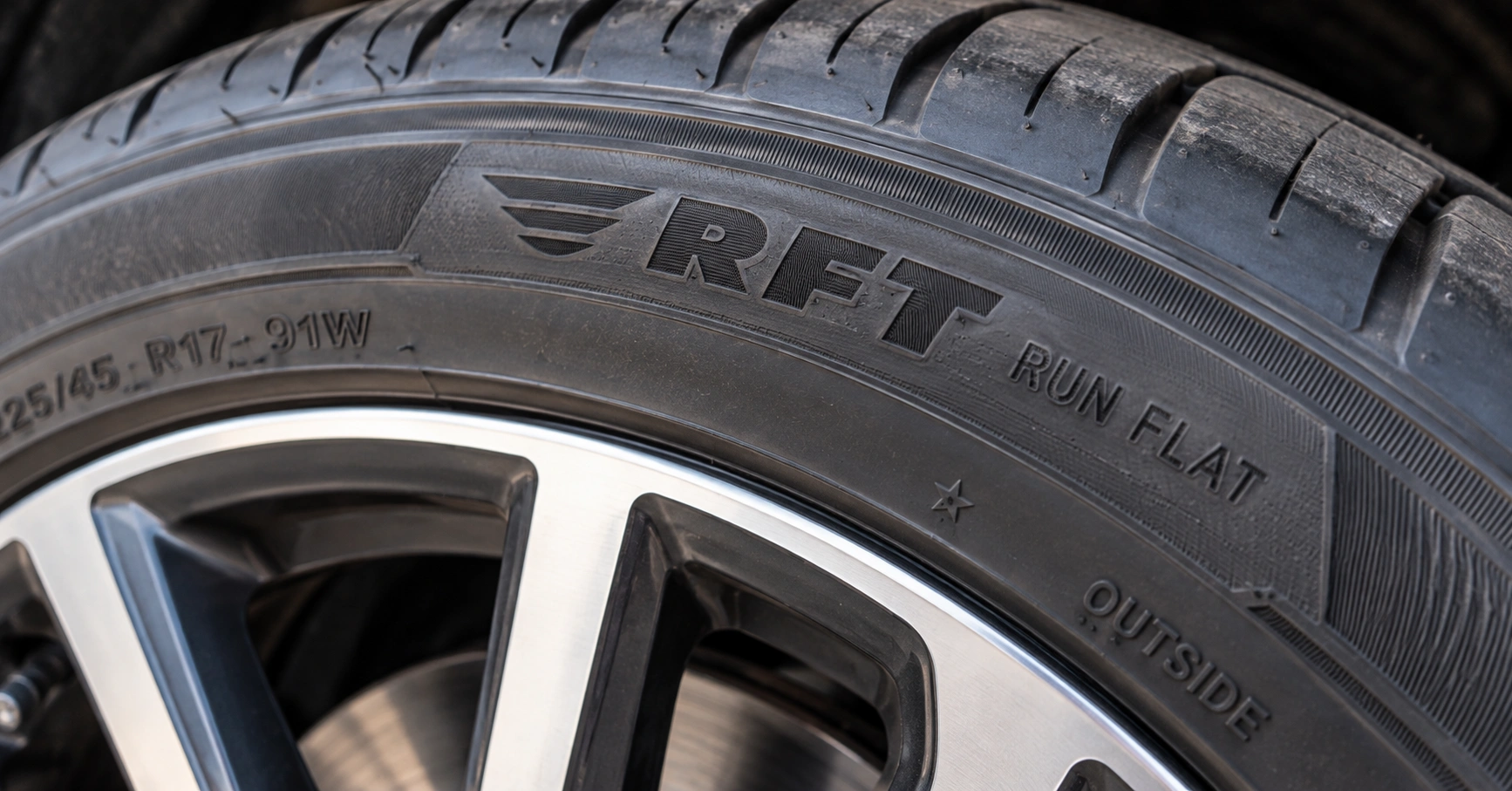 Close-up of a run-flat car tyre sidewall showing the RFT and Run Flat markings
